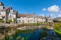 Picturesque Dorset village homes and overlooking the river on a sunny day